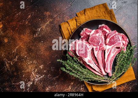 https://l450v.alamy.com/450v/2r8964h/raw-lamb-chops-fresh-mutton-meat-cutlets-on-a-ribs-dark-background-top-view-copy-space-2r8964h.jpg