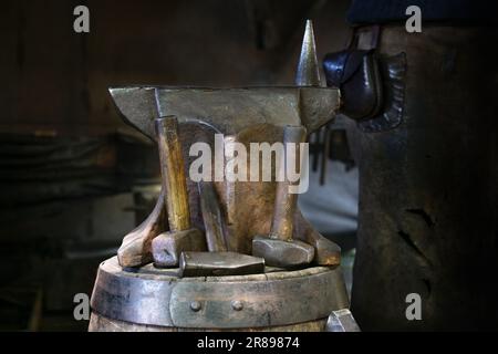 Anvil and various hammers in a portable blacksmith workshop, forge demonstration at a traditional craft market, copy space, selected focus, narrow dep Stock Photo