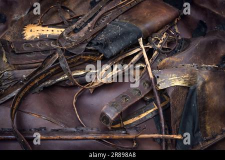 Old brown leather from belts, bags and furniture collected in a recycle workshop where used material is turned into something new, copy space, selecte Stock Photo
