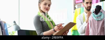 Two fashion designers man and woman are working on new collection of clothes Stock Photo