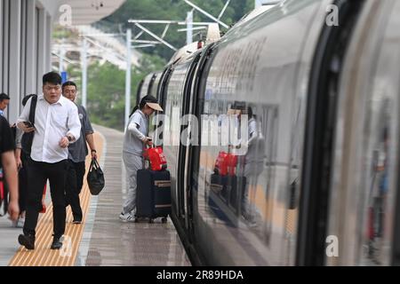 (230620) -- SHENGZHOU, June 20, 2023 (Xinhua) -- Passengers board a train at Xinchang Railway Station on the Hangzhou-Shaoxing-Taizhou intercity railway in east China's Zhejiang Province, June 19, 2023. The Hangzhou-Shaoxing-Taizhou intercity railway is among China's first group of high-speed railway projects funded by a public-private partnership (PPP), with the private sector having a holding status. Since the railway's official operation in January 2022, more than 10 million passengers have travelled along it. The 266.9-kilometer rail line, with a designed speed of 350 kilometers per hour, Stock Photo