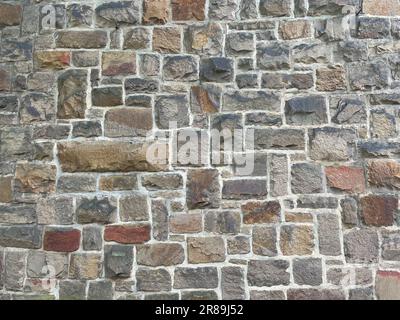 Stone Wall Texture with big bricks on ancient historic church in Germany, Europe. Can be used as a texture or background. Handcrafted old wall. Mediev Stock Photo