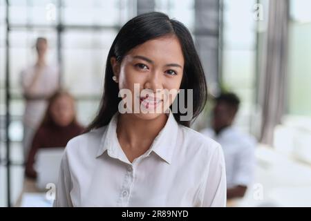 Young beautiful Asian business woman consultant , portrait of an employee looking at the camera Stock Photo