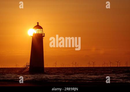 Sunset over Point of Ayr lighthouse, Talacre, North Wales Stock Photo
