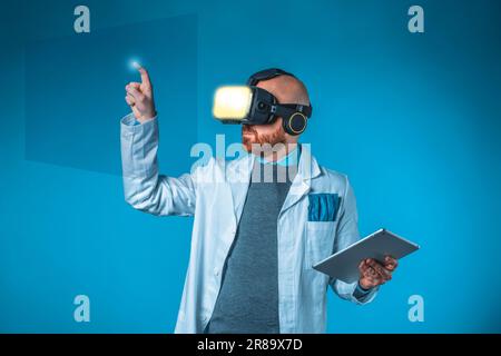 Photo of male doctor with 3d glasses, tablet, blue background and medical white coat Stock Photo