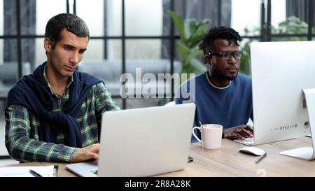 Young multiethnic businessmen working at the negotiating table Stock Photo