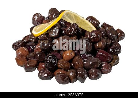 Black olive isolated on white background. Fermented olives and lemon slice in plate. Mediterranean flavors Stock Photo