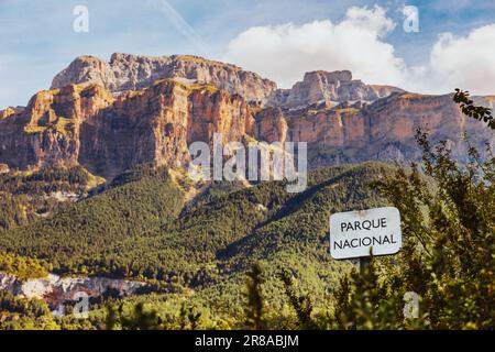 Ordesa National Park sign with the mountains and the natural environment behind. Ordesa y Monte Perdido National Park is in the heart of the Pyrenees Stock Photo