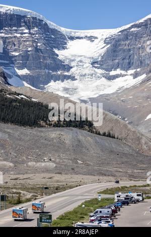 Pair of Motor Homes travelling on the Icefield Parkway in front of large glacier in Jasper National Park, Alberta, Canada on 6 June 2023 Stock Photo