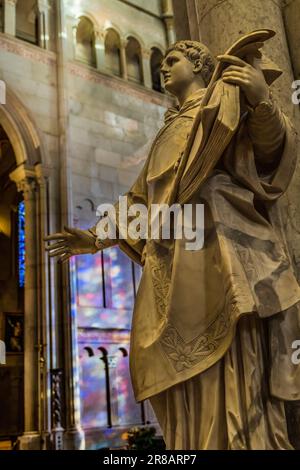 Angel Statue Stained Glass Reflection St John the Baptist Cathedral Basilica Lyon France. Cathedral begun in 11800 and finished in 1480. Stock Photo