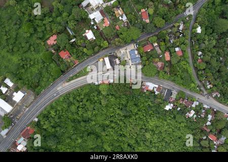 Road intersection in green nature background aerial above top drone view Stock Photo