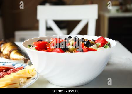 closeup shot of a classic Greek salad. Made with juicy tomatoes, crisp cucumbers, red pepper, onion, and adorned with olives, oregano, and feta cheese Stock Photo