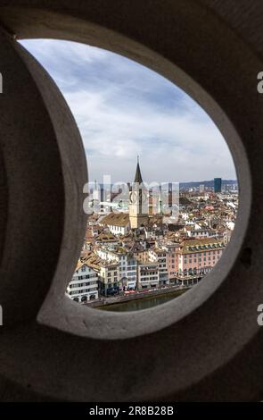 Zurich, Switzerland - March 26. 2021: Zurich downtown and St. Peter Church viewed through wall frame on the top of the church Grossmunster Stock Photo