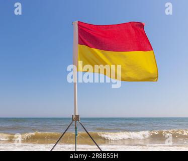 Swimming safety lifeguard flag erected by the RNLI on the beach in Southwold, Suffolk. UK Stock Photo