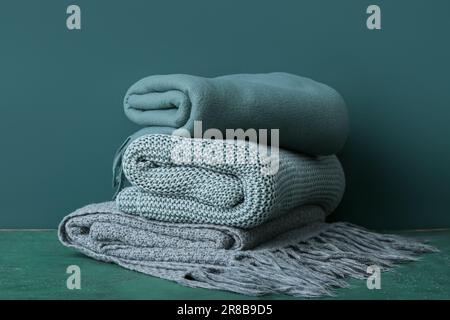New soft folded blankets on green background Stock Photo