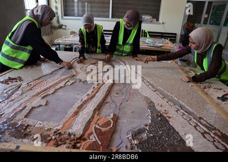 Palestinian girls arranges tiles into a mosaic mural at aassociation in Khan Yunis the southern Gaza Strip on Tuesday, June 20, 2023. Photo by Ismael Mohamad/ Credit: UPI/Alamy Live News Stock Photo