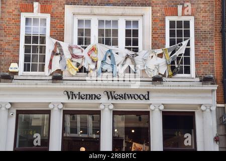 London, UK - 19th June 2023. Clothes spell out 'Assange' outside the Vivienne Westwood flagship store in Conduit Street. Stock Photo