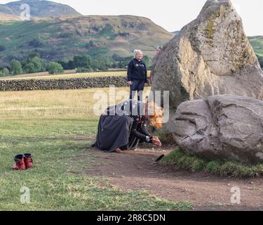 A person performs a dance in front of the stones as the sun begins to set during the Castlerigg Stone Circle Summer Solstice Celebration. It's believed Castlerigg Stone Circle was constructed around 3200 BC, and although its original purpose remains largely unknown, possible uses include a trading post, meeting place, a religious site or an astronomical observatory.Castlerigg Stone Circle, Keswick, United Kingdom, 20th June 2023 (Photo by Mark Cosgrove/News Images) in Keswick, United Kingdom on 6/20/2023. (Photo by Mark Cosgrove/News Images/Sipa USA) Stock Photo