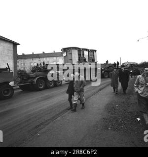 Current 57-3-1960: Giant on city tour Forty wheels rolled in unison from Hasle to Ulven in Oslo the other day. They carried out a historic job: The largest Norwegian-built transformer to date – a giant of 205 tonnes – was transported from Per Kure A/S to the lighting company's facility at Ulven, where it will help with the power supply. The transformer, which produces 161,000 kilovoltampères, is 9.6 meters long and 5.7 meters wide. Oslo Lysverker had called in reinforcements for the large transport and no less than two drivers were in business. They received their driving orders from the comma Stock Photo