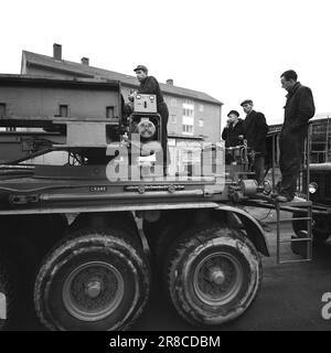 Current 57-3-1960: Giant on city tour Forty wheels rolled in unison from Hasle to Ulven in Oslo the other day. They carried out a historic job: The largest Norwegian-built transformer to date – a giant of 205 tonnes – was transported from Per Kure A/S to the lighting company's facility at Ulven, where it will help with the power supply. The transformer, which produces 161,000 kilovoltampères, is 9.6 meters long and 5.7 meters wide. Oslo Lysverker had called in reinforcements for the large transport and no less than two drivers were in business. They received their driving orders from the comma Stock Photo