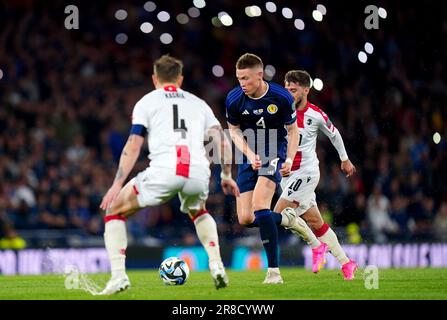 Scotland's Scott McTominay and Georgia's Guram Kashia battle for the ball during the UEFA Euro 2024 Qualifying Group A match at Hampden Park, Glasgow. Picture date: Tuesday June 20, 2023. Stock Photo