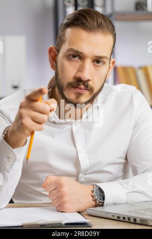 Conflict Quarrel Negotiation. Angry boss business man making online video call, talking colleague conversation analyzing financial report mistake problem. Guy at office looking at camera. Vertical Stock Photo