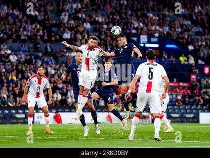 Scotland's John McGinn and Georgia's Guram Kashia battle for the ball during the UEFA Euro 2024 Qualifying Group A match at Hampden Park, Glasgow. Picture date: Tuesday June 20, 2023. Stock Photo