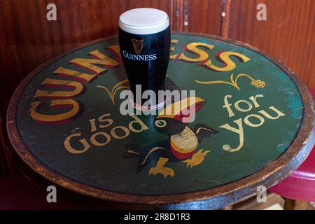 Pint glass of Guiness at the Auld Shillelagh Stoke Newington Church St, London, UK Stock Photo