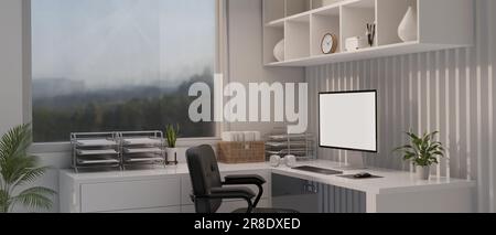 Interior design of a modern white office workspace with a computer white screen mockup and office supplies on a white corner table against the window Stock Photo