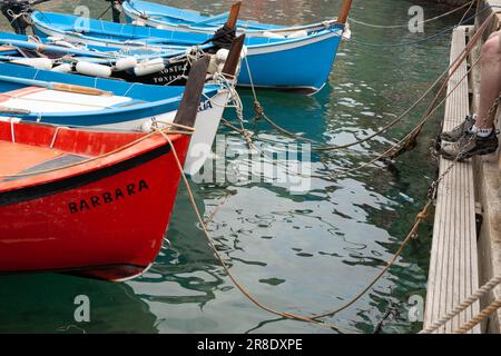 Vernazza Italy - April 24 2011; Quaint European boats moored or tied up in Cinque Terre fishing village and popular tourist destination. Stock Photo