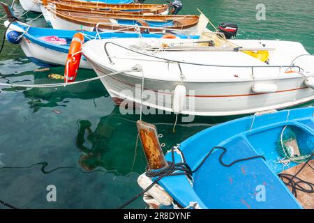 Vernazza Italy - April 24 2011; Quaint European boats moored or tied up in Cinque Terre fishing village and popular tourist destination. Stock Photo