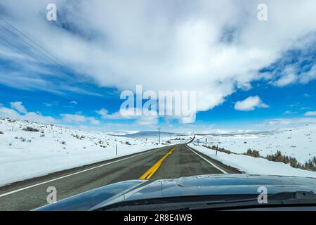 USA, Idaho, Bellevue, Highway through snow-covered landscape as seen from car Stock Photo