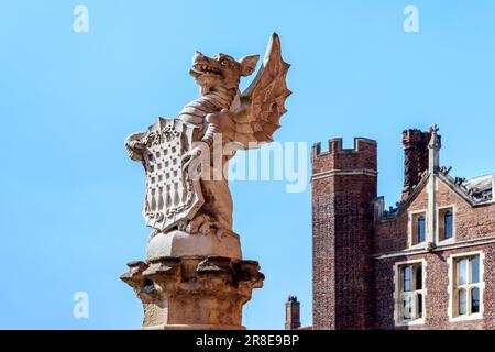 HAMPTON, GREAT BRITAIN - MAY 18, 2014: It is one of the griffin with a coat of arms at the entrance to the Hampton Court Palace. Stock Photo