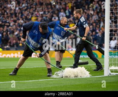 GLASGOW, SCOTLAND - JUNE 20: Groundsmen work to dry the pitch during the UEFA EURO 2024 qualifying round group A match between Scotland and Georgia at Hampden Park on June 20, 2023 in Glasgow, Scotland. (Photo by Ian Jacobs/MB Media/) Stock Photo