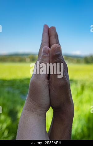 Black male and white female hands touching palms each other. Interracial couple holding hands outdoors. White caucasian and black afro american hands Stock Photo