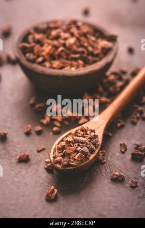 Organic cacao nibs in small bowl Stock Photo