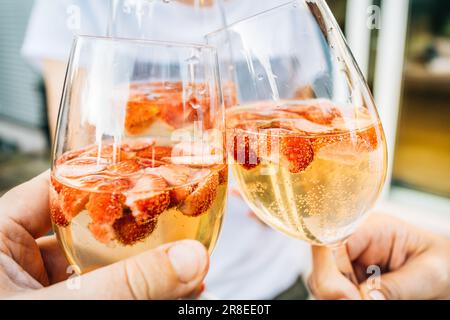 Summer strawberry wine cocktail, toasting with refreshing drinks Stock Photo