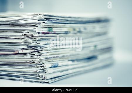Pile of newspapers on table.  Folded and stacked journals. Stock Photo