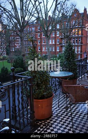 Exterior European design and architecture decoration of British hotel, balcony and terrace facing natural green public park- London, UK Stock Photo