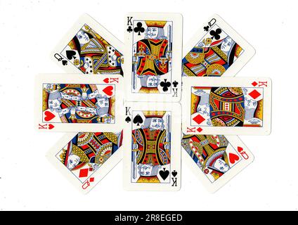 A display of vintage playing cards featuring kings and queens on a white background. Stock Photo