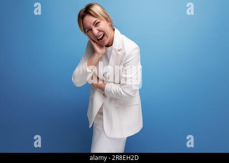 pretty young blond career woman in business style makes a grimace Stock Photo