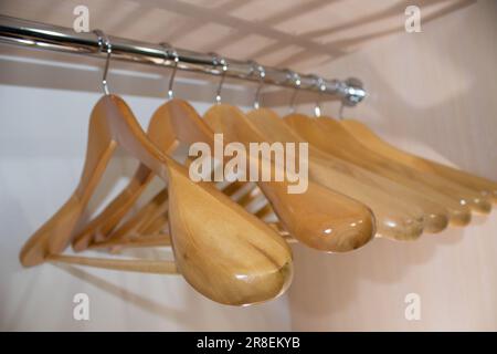 wooden hangers for top clothes in the closet Stock Photo