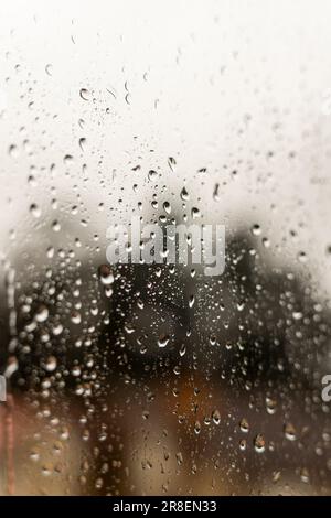 A closeup of a window covered in raindrops Stock Photo