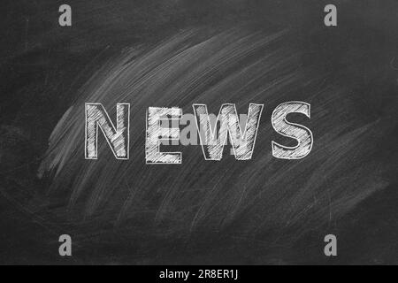 The word NEWS written in chalk on a blackboard. Hand drawn illustration. Stock Photo