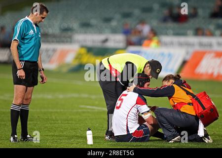 Tasman's Joe Wheeler receives medical attention watched by referee Glen Jackson whilst playing against North Harbour Stock Photo