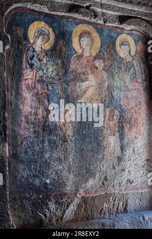 Mother Mary and Jesus icons on the wall of  Gümüşler Monastery and Underground City in the city of Niğde of Turkey country. 05.21.2023 Stock Photo