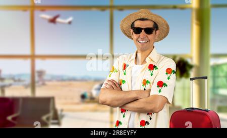 Latin man on vacation wearing floral shirt hat sunglasses at airport happy face smiling with crossed arms looking at the camera. Positive person. Stock Photo