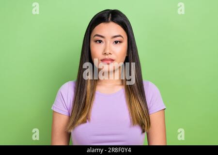 Photo portrait of attractive vietnamese chinese young woman look camera dressed stylish violet clothes isolated on green color background Stock Photo