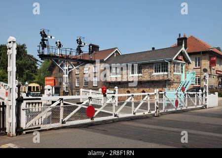 Level crossing gates, semaphore signal gantry and signal box at Grosmont station, North Yorkshire Moors Railway, UK. Stock Photo