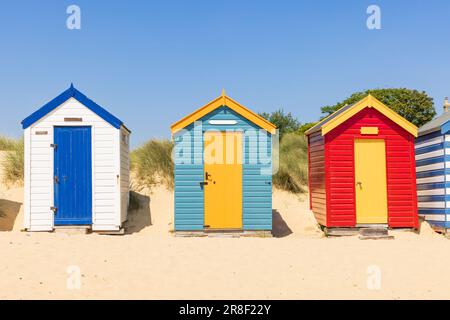 Colourful wooden beach huts on the sandy beach in Southwold, Suffolk. UK Stock Photo